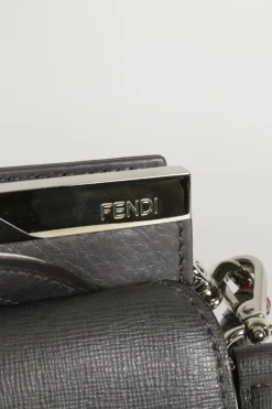 Grey pebbled leather bag with front flap, magnetic clasp and short top handle.