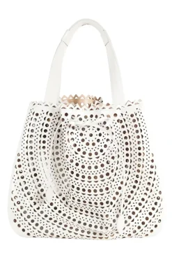 Grey perforated leather top handle bag. Drawstring closure. Bag comes with detachable leather zip pouch