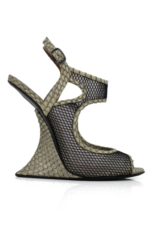 Grey snake skin wedge sandals with black mesh details and curved heels.