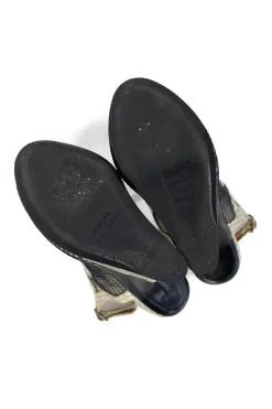Grey snake skin wedge sandals with black mesh details and curved heels.
