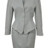 Grey wool two-piece skirt suit featuring spread collar sculpted jacket and slit-front pencil skirt