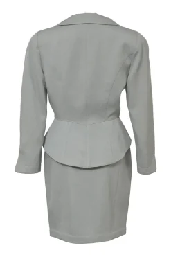 Grey wool two-piece skirt suit featuring spread collar sculpted jacket and slit-front pencil skirt