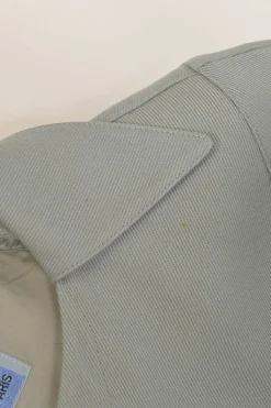 Grey wool two-piece skirt suit featuring spread collar sculpted jacket and slit-front pencil skirt