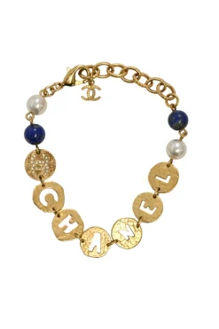 Hammered gold-tone metal, enamel, and resin cutout logo charm bracelet with lobster-clasp closure