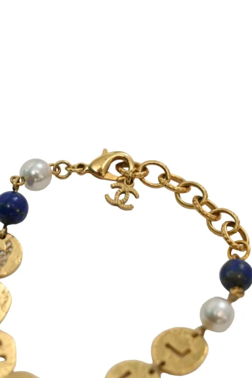 Hammered gold-tone metal, enamel, and resin cutout logo charm bracelet with lobster-clasp closure
