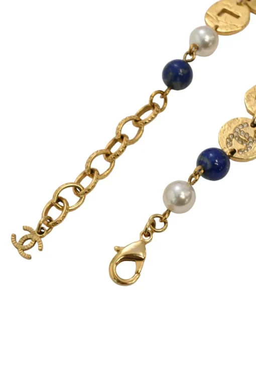 Hammered gold-tone metal, enamel, and resin cutout logo charm bracelet with lobster-clasp closure