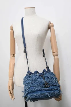 Indigo lambskin leather and fringed cotton denim crossbody bucket bag with silver-tone hardware
