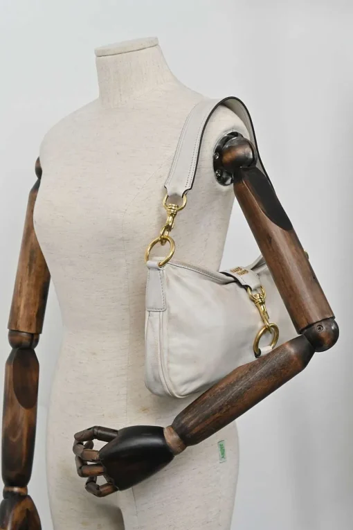 Ivory aged leather snap hook shoulder bag with gold-tone metallic hardware