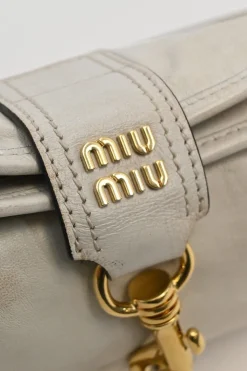 Ivory aged leather snap hook shoulder bag with gold-tone metallic hardware