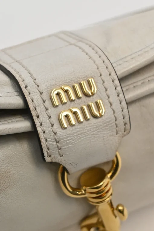 Ivory aged leather snap hook shoulder bag with gold-tone metallic hardware