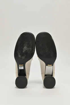 Ivory and black grained calfskin square-toe block heel chain detail loafers