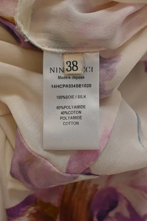 Ivory and purple silk painterly floral print roll neck jumpsuit with drawstring waist and tonal lace inserts