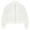 Ivory cotton broderie Anglaise peek-a-book zip-up bomber jacket with ribbed collar, cuffs, and hem