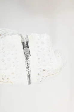 Ivory cotton broderie Anglaise peek-a-book zip-up bomber jacket with ribbed collar, cuffs, and hem