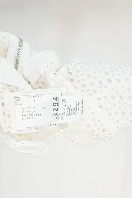 Ivory cotton broderie Anglaise peek-a-book zip-up bomber jacket with ribbed collar, cuffs, and hem