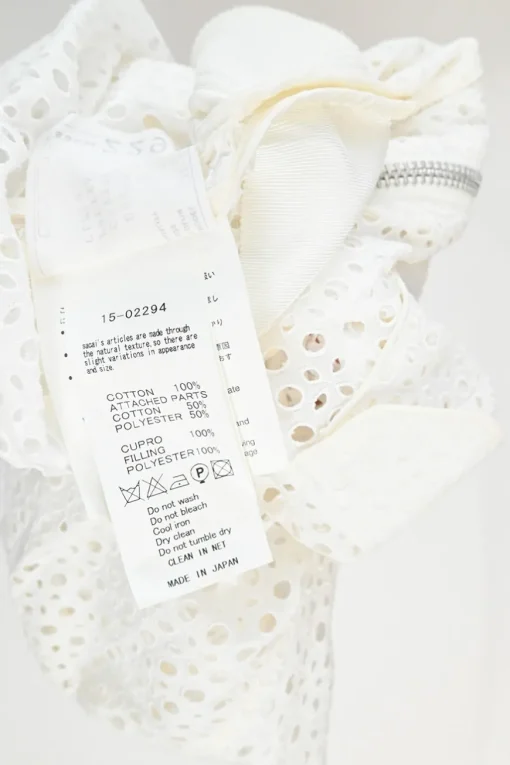 Ivory cotton broderie Anglaise peek-a-book zip-up bomber jacket with ribbed collar, cuffs, and hem