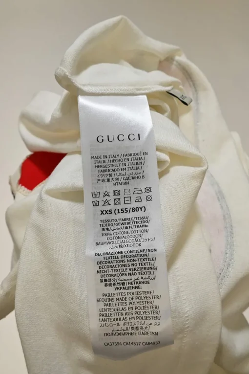 Ivory screen-printed cotton jersey crewneck pullover T-shirt featuring GG apple motif at centre front