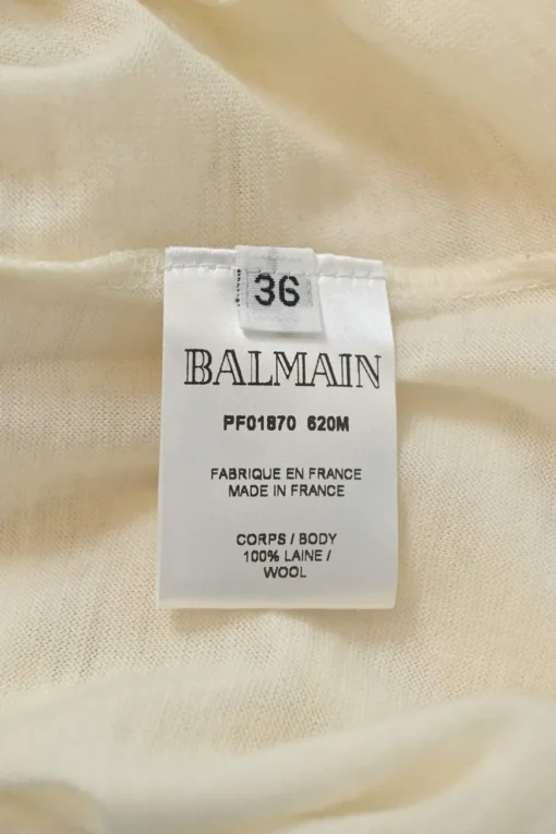 Ivory semi-sheer wool interlock jersey funnel collar pullover long sleeve top with coat of arms shoulder line shank button appliqué