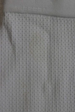 Ivory viscose-blend fully-fashioned pull-on pointelle mini pencil knit skirt with curved asymmetric hem