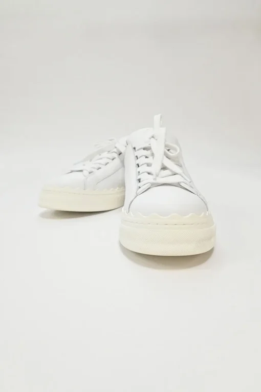 Ivory white calfskin and rubber low-top Lauren sneakers with scalloped sole motif