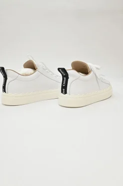 Ivory white calfskin and rubber low-top Lauren sneakers with scalloped sole motif