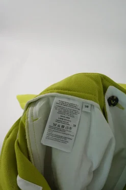 Lime green wool pull-on high-rise pleated trousers with waist adjuster and tab cuffs