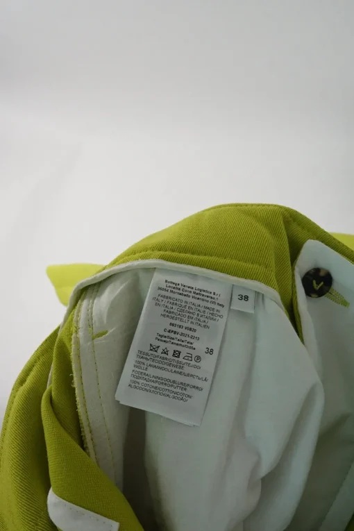 Lime green wool pull-on high-rise pleated trousers with waist adjuster and tab cuffs