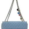 Limited release blue matelassé leather Valentine East West flap bag with enamel logo charm strap appliqué