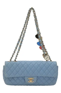 Limited release blue matelassé leather Valentine East West flap bag with enamel logo charm strap appliqué