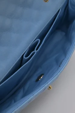 Limited release blue matelassé leather Valentine East West flap bag with enamel logo charm strap appliqué