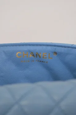 Limited release blue matelassé leather Valentine East West flap bag with enamel logo charm strap appliqué