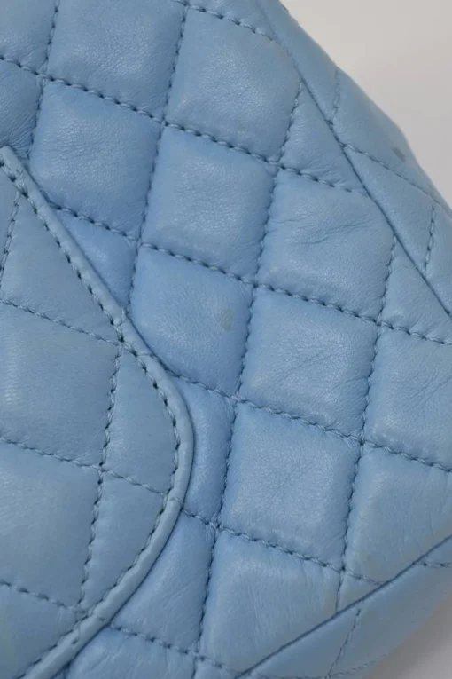 Limited release blue matelassé leather Valentine East West flap bag with enamel logo charm strap appliqué