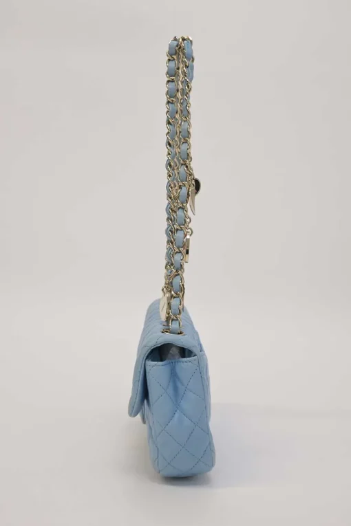 Limited release blue matelassé leather Valentine East West flap bag with enamel logo charm strap appliqué