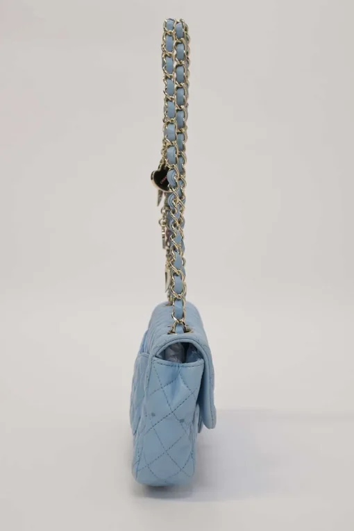 Limited release blue matelassé leather Valentine East West flap bag with enamel logo charm strap appliqué