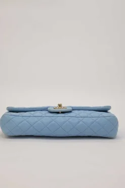 Limited release blue matelassé leather Valentine East West flap bag with enamel logo charm strap appliqué