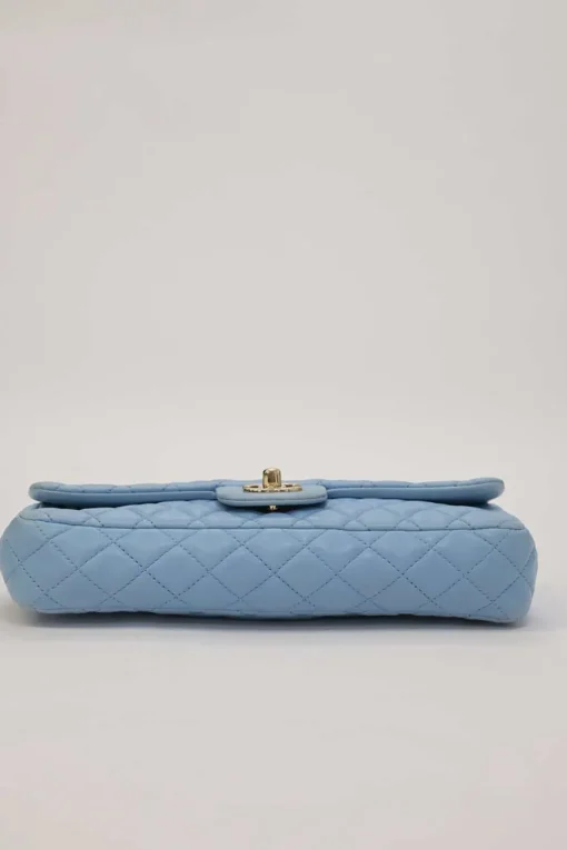 Limited release blue matelassé leather Valentine East West flap bag with enamel logo charm strap appliqué