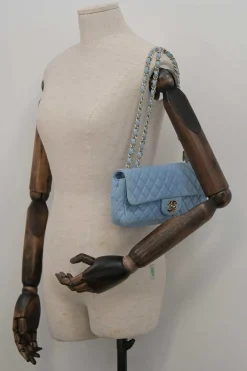 Limited release blue matelassé leather Valentine East West flap bag with enamel logo charm strap appliqué