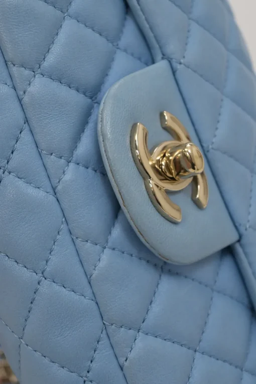 Limited release blue matelassé leather Valentine East West flap bag with enamel logo charm strap appliqué