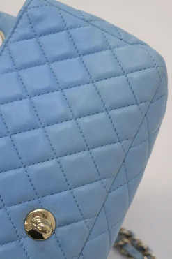 Limited release blue matelassé leather Valentine East West flap bag with enamel logo charm strap appliqué