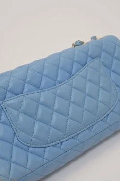 Limited release blue matelassé leather Valentine East West flap bag with enamel logo charm strap appliqué