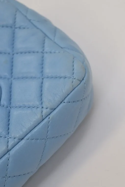 Limited release blue matelassé leather Valentine East West flap bag with enamel logo charm strap appliqué