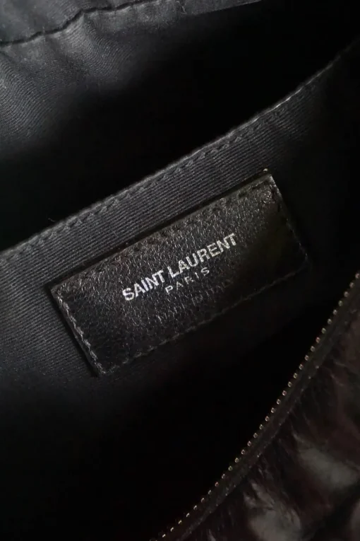 Lou camera bag; MONOGRAM SHOULDER BAG in wrinkled black leather with  AN ADJUSTABLE LEATHER STRAP.