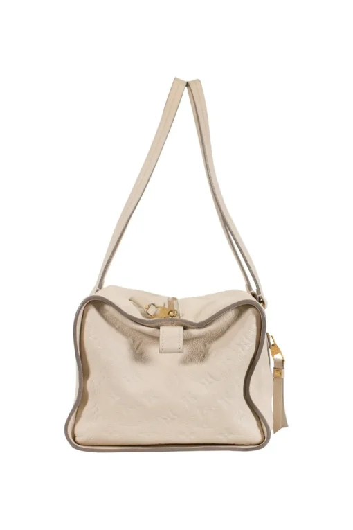 Louis Vuitton Empreinte monogram embossed calf leather bag in cream colour with zip closure. Rectangular shape with 2 shoulder straps. Bag has one external zipped pocket. Interior is fabric lined, with two side pockets, and a third on front panel. Gold toned hardware.