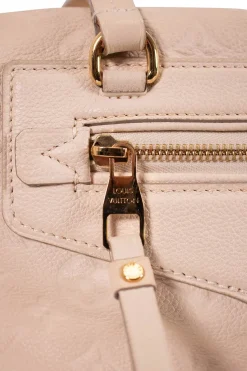 Louis Vuitton Empreinte monogram embossed calf leather bag in cream colour with zip closure. Rectangular shape with 2 shoulder straps. Bag has one external zipped pocket. Interior is fabric lined, with two side pockets, and a third on front panel. Gold toned hardware.