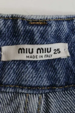 Mid-wash indigo cotton denim high-rise wide-leg jeans with logo-embroidered rear patch pocket