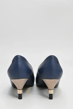 Navy and black contrast leather almond-toe pumps with patterned gold-tone metal heels and black Coco logo on ankle counter