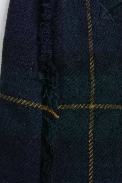 Navy and green plaid pull-on micro-mini skirt with unfinished raw edges and slanted smile pockets