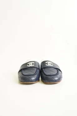 Navy and white quilted leather square-toe mules with beaded Coco Mark at vamp