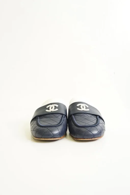 Navy and white quilted leather square-toe mules with beaded Coco Mark at vamp