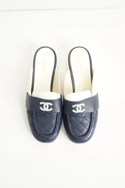Navy and white quilted leather square-toe mules with beaded Coco Mark at vamp